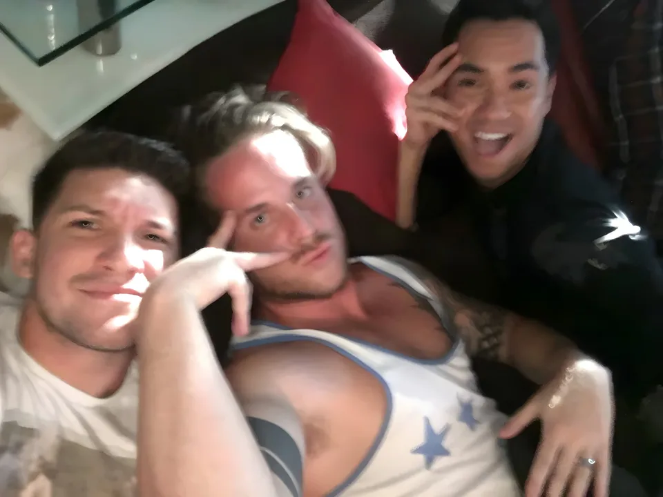 Blurry trio laughing late at night indoors