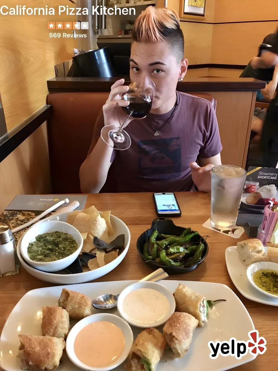 Young man sipping red wine at a restaurant